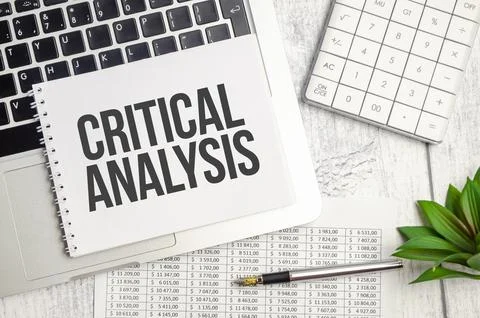 CRITICAL ANALYSIS text and notepad with pen, charts and calculator Stockfoto's