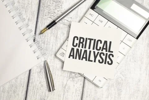 CRITICAL ANALYSIS, text on white sticker and calculator on wooden background Stock Photos