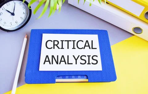 Critical analysis text written on white paper above Notebook. Concept of care Stock Photos