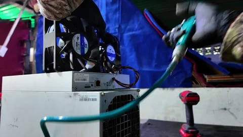 Critical Dust Cleaning: Maintaining ASIC Hardware for Maximum Crypto Efficiency Stock Footage 323798464