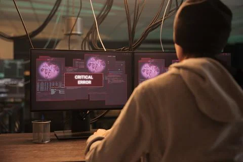 Critical error alert on multiple monitors late at night Stock Photos