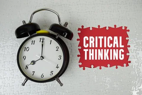Critical Thinking text with alarm clock on red background Stock Photos