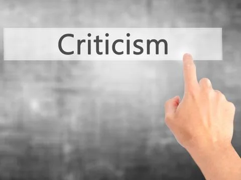 Criticism - Hand pressing a button on blurred background concept on visual sc Stock Photos
