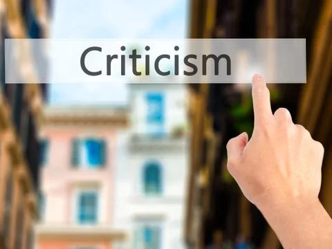 Criticism - Hand pressing a button on blurred background concept on visual sc Foto stock