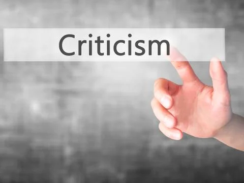 Criticism - Hand pressing a button on blurred background concept on visual sc Stock Photos