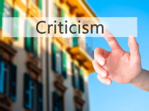 Criticism - Hand pressing a button on blurred background concept on visual sc Foto stock