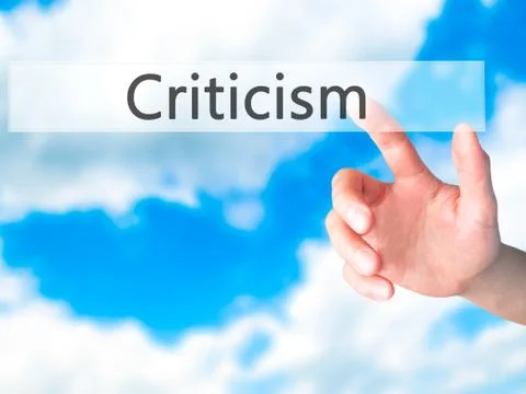 Criticism - Hand pressing a button on blurred background concept on visual sc Stock Photos
