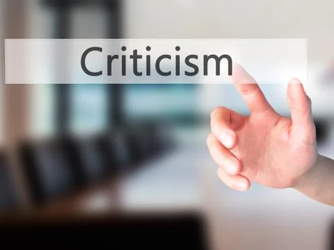 Criticism - Hand pressing a button on blurred background concept on visual sc 库存照片