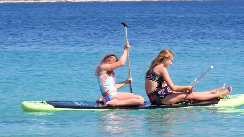 Croatia, Marina, Split-Dalmatia, August 21, 2019. Two young girls in bathing Stock Footage 124497984
