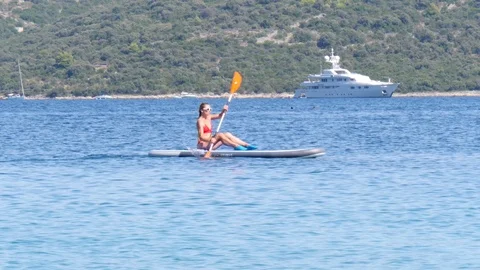 Croatia, Marina, Split-Dalmatia, August 21, 2019. A young girl in a red Stock Footage 124689296