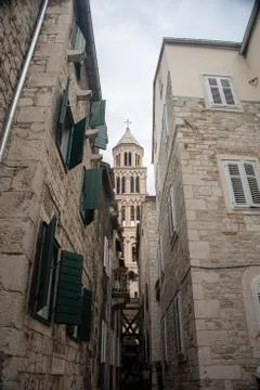 Croatia, Split - June 2018: View of the Cathedral tower though the narrow str Stock Photos