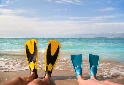 Croatia, Zadar, Couple with flippers relaxing on beach Stock Photos