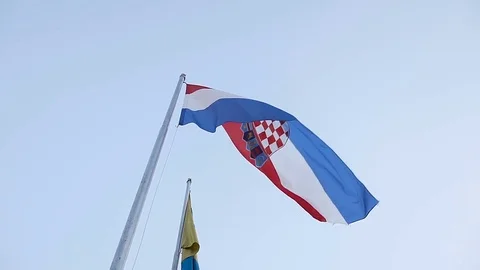The Croatian flag flies against the background of a blue sky Stock Footage