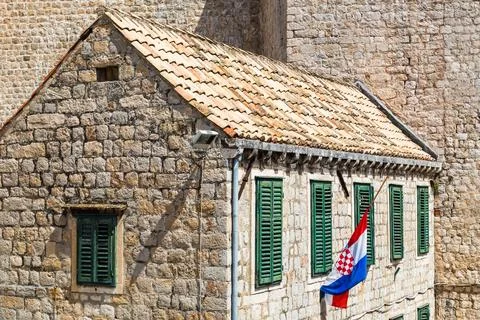 Croatian flag by a rustic building Stock Photos