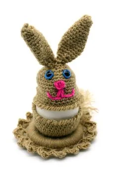 Crochet Easter bunny egg cup made of wool on white isolated background. Stock Photos