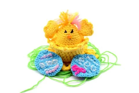 Crochet Easter egg cup in chicken shape with easter eggs and greeen wool gras Stock Photos