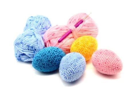 Crochet easter eggs in blue pink yellow on isolated background Stock Photos