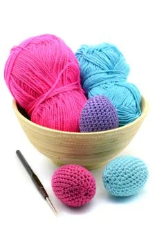 Crochet easter eggs with wool ball in background Stock Photos