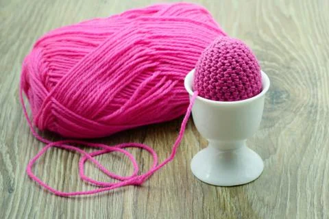 Crochet easter eggs with wool ball in background Stock Photos