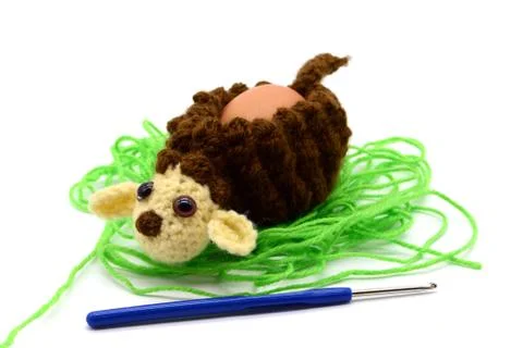 Crochet Easter lamb egg cup made of wool with crochet hook Stock Photos
