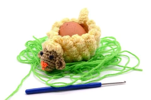 Crochet Easter lamb egg cup made of wool with crochet hook Stock Photos