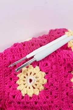 Crochet handmade granny square pattern, crocheting supplies. Stock Photos