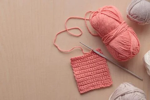 Crochet handmade square pattern, pink yarn coil, hook, knitting crocheting .. Stock Photos