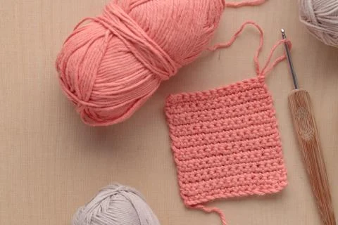 Crochet handmade square pattern, pink yarn coil, hook, knitting crocheting .. Stock Photos