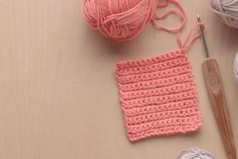 Crochet handmade square pattern, pink yarn coil, hook, knitting crocheting .. Stock Photos