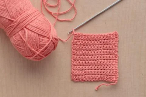 Crochet handmade square pattern, pink yarn coil, hook, knitting crocheting .. Stock Photos