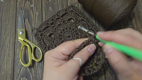 A crochet pattern of brown squares, perfect for home decor and fashion. Stock Footage 328639685