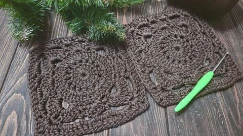 A crochet pattern of brown squares, perfect for home decor and fashion. On a  Stock Photos