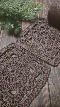 A crochet pattern of brown squares, perfect for home decor and fashion. On a  Stock Photos