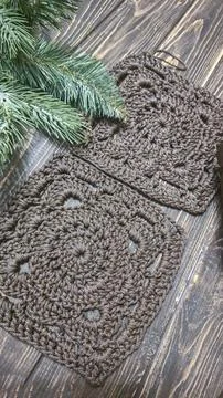 A crochet pattern of brown squares, perfect for home decor and fashion. On a  Stock Photos