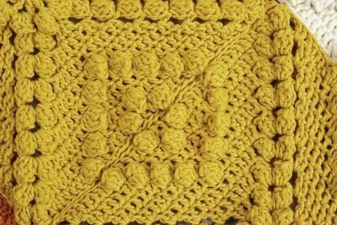 Crochet pattern with bubble stich yellow colored Stock Photos