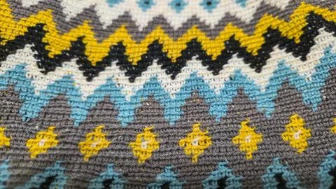 Crochet pattern of multicolored threads. Yellow with gray, black and other co Foto stock