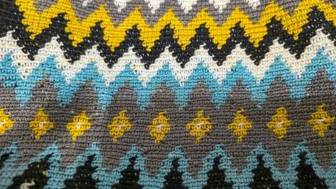 Crochet pattern of multicolored threads. Yellow with gray, black and other co Stock Photos