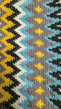 Crochet pattern of multicolored threads. Yellow with gray, black and other co Foto stock