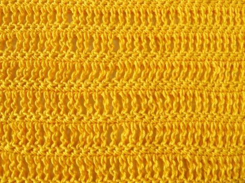 Crochet pattern from single and triple crochet stitch in yellow Foto stock