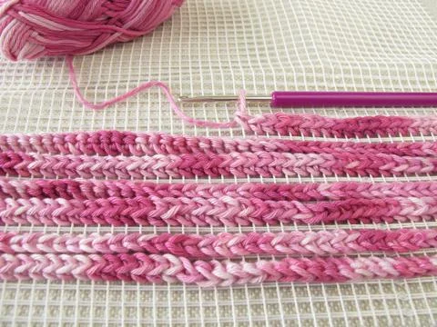 Crochet pattern on woven material Stock-Fotos