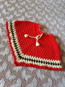 Crochet red poncho Stock Photos
