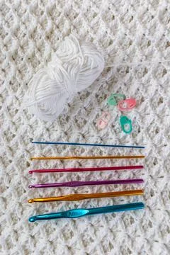Crochet stitch pattern, crochet hooks, markers and cotton ball Stock Photos