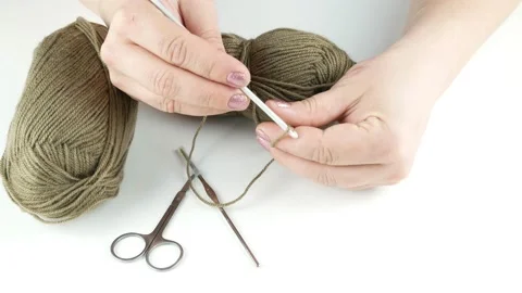 Crochet woolen threads.On the table are brown threads and metal scissors. 스톡 동영상 139010365