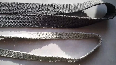 Crocheted belt made of gray yarn, cord, handmade Stock Footage 241348308