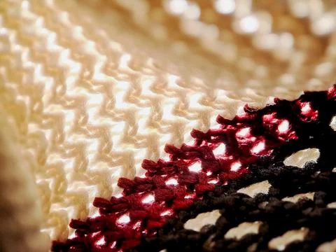Crocheted fabric with a mesmerizing interplay of white, burgundy, and black.. Stock Photos