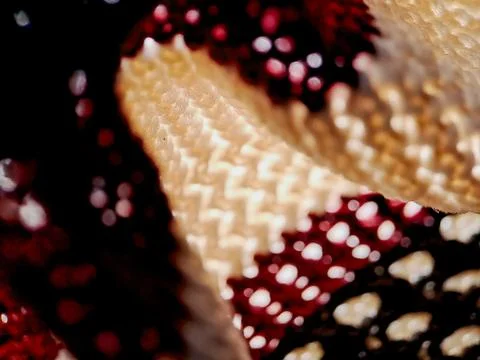 Crocheted fabric with a mesmerizing interplay of white, burgundy, and black.. Stock Photos