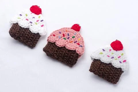 Crocheted keychains in the shape of cupcakes of various flavors Stock Photos