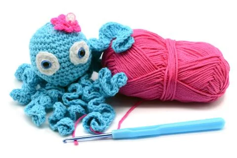 Crocheted octopus of wool on white isolated  background Stock Photos