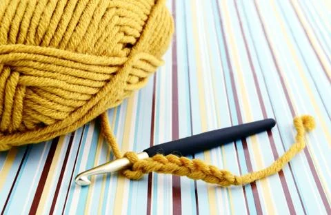 Crocheting with brown wool Stock Photos
