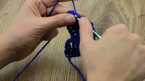 Crocheting single stitches of blue wool. wooden bachground 스톡 동영상 123650502